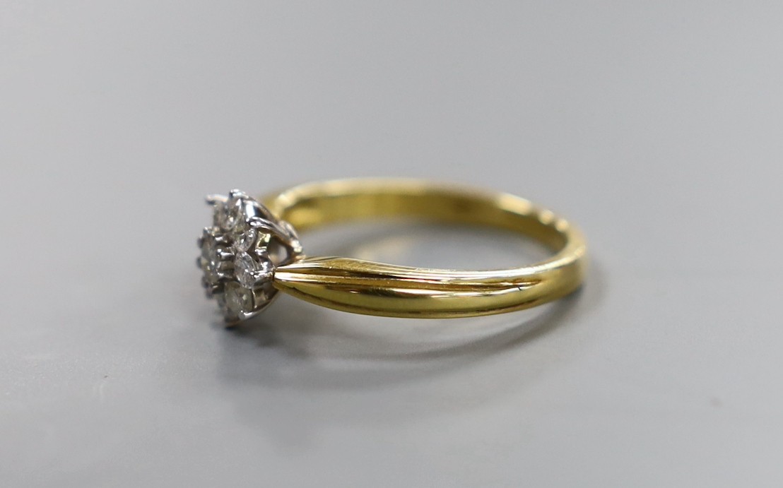 A modern 18ct gold and nine stone diamond cluster set flower head ring, size O/P, gross weight 4.4 grams